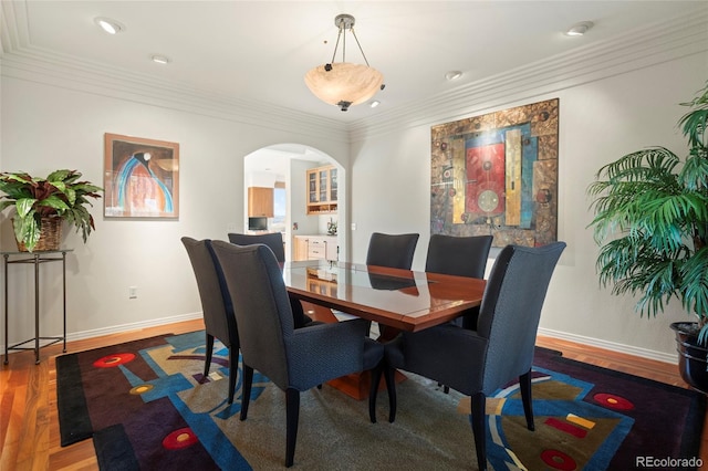 dining room featuring hardwood / wood-style floors and ornamental molding