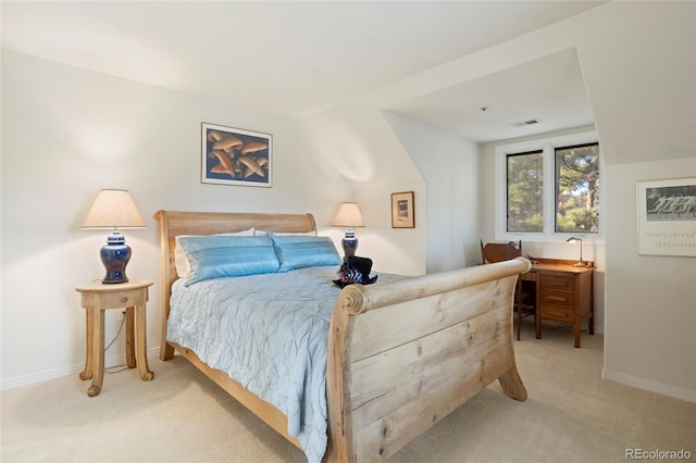 bedroom featuring light carpet and vaulted ceiling