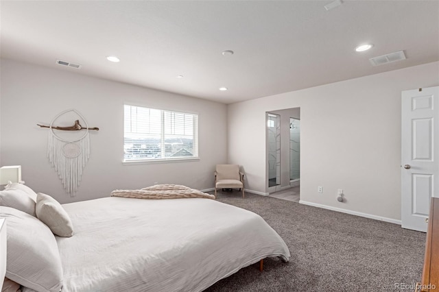 bedroom featuring ensuite bath and carpet floors