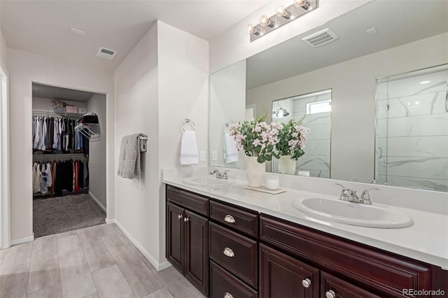 bathroom featuring hardwood / wood-style flooring, vanity, and an enclosed shower