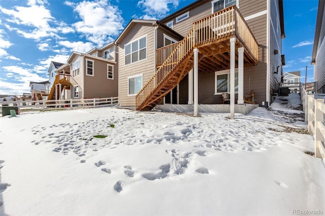 view of snow covered back of property