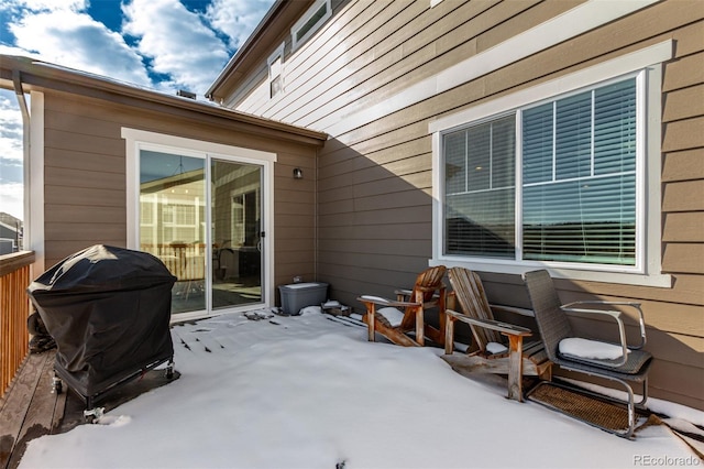 snow covered patio featuring area for grilling