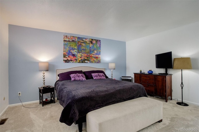 bedroom with baseboards, carpet floors, and visible vents