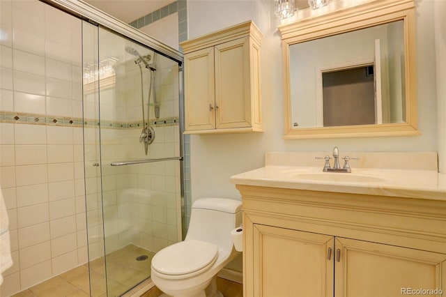 bathroom featuring vanity, toilet, and a shower stall