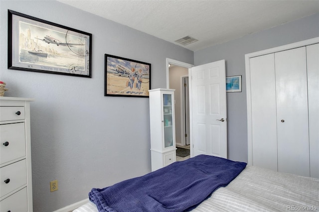 bedroom with visible vents and a closet