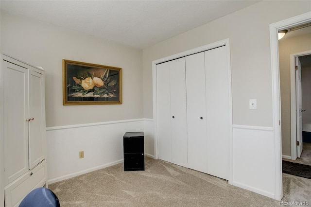 unfurnished bedroom with a closet, baseboards, and carpet floors