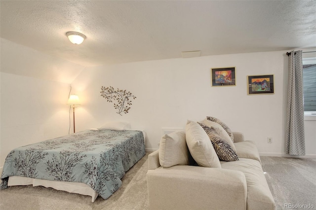 carpeted bedroom with baseboards, a textured ceiling, and vaulted ceiling