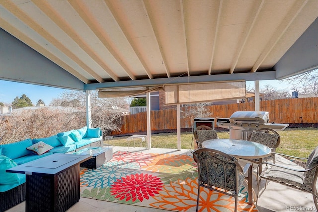 view of patio featuring outdoor dining space, a grill, a fenced backyard, and an outdoor hangout area