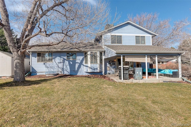 back of property with a patio area, an outdoor hangout area, a shingled roof, and a yard