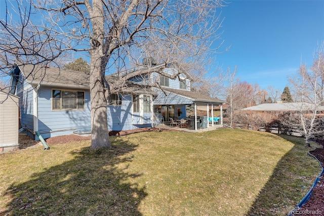 back of house featuring a patio and a lawn