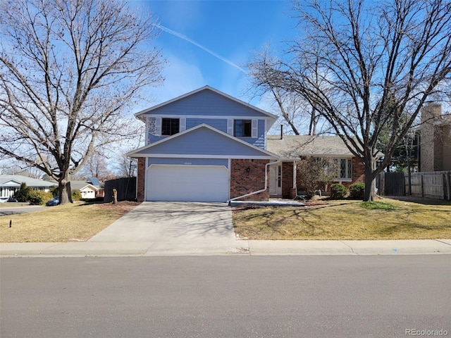 traditional-style home featuring brick siding, a front lawn, fence, concrete driveway, and an attached garage