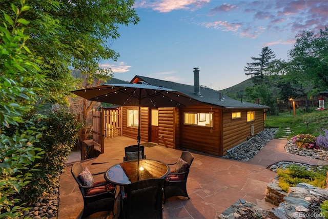 2874 SE Grapevine Rd, Idledale, CO 80453 - patio terrace at dusk featuring a patio area and outdoor dining space