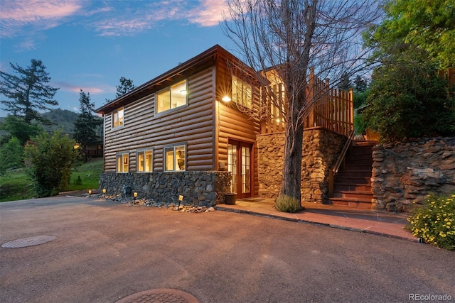 2874 SE Grapevine Rd, Idledale, CO 80453 - view of front of home with stone siding, log veneer siding, and stairs