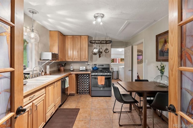 2874 SE Grapevine Rd, Idledale, CO 80453 - kitchen with appliances with stainless steel finishes, washer and clothes dryer, light countertops, and plenty of natural light