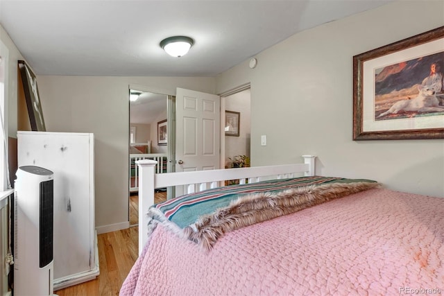 2874 SE Grapevine Rd, Idledale, CO 80453 - bedroom with light wood-style floors and heating unit