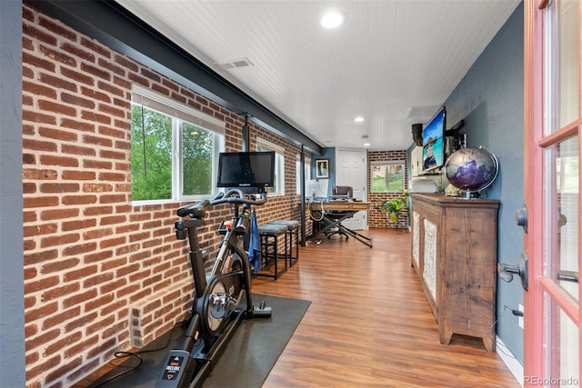 2874 SE Grapevine Rd, Idledale, CO 80453 - exercise area with wood finished floors, recessed lighting, and brick wall