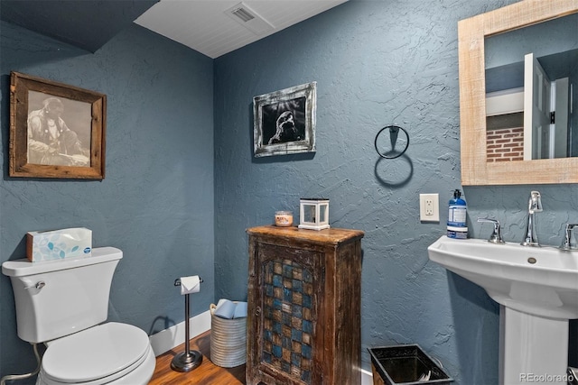 2874 SE Grapevine Rd, Idledale, CO 80453 - bathroom with wood finished floors and toilet