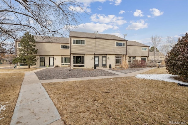 rear view of house featuring a yard