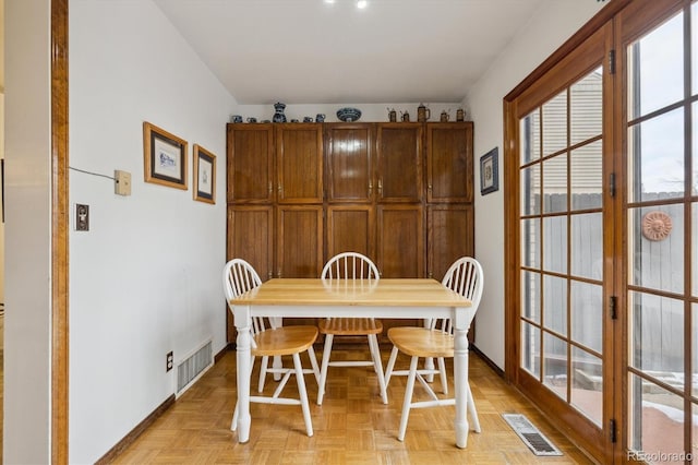 dining area featuring french doors, visible vents, and baseboards