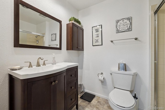 full bathroom with visible vents, toilet, an enclosed shower, vanity, and baseboards