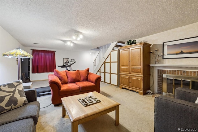 living area featuring a brick fireplace, light carpet, stairway, and a textured ceiling