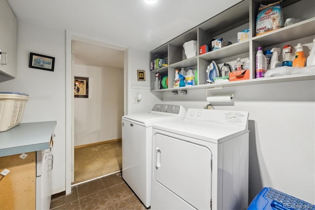 washroom featuring baseboards, laundry area, dark carpet, and washer and dryer