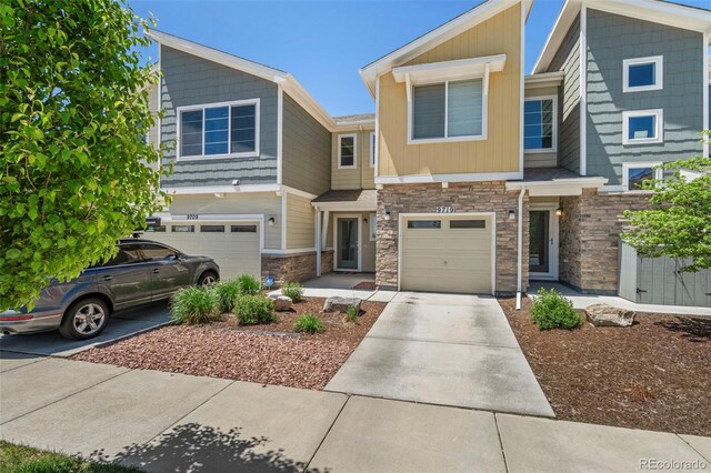9719 Albion Ln, Thornton, CO 80229 - multi unit property with stone siding, a garage, and driveway