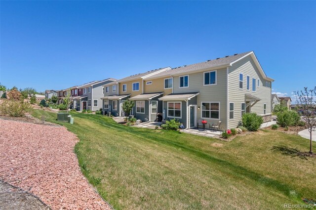 9719 Albion Ln, Thornton, CO 80229 - back of house with a patio, a residential view, and a yard