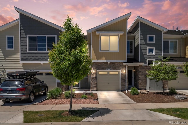 9719 Albion Ln, Thornton, CO 80229 - townhome / multi-family property with a garage, stone siding, and concrete driveway