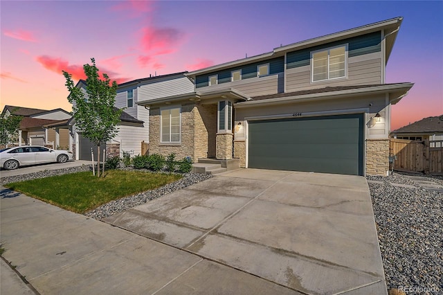 4644 Hatcher Dr, Brighton, CO 80601 - view of front facade with stone siding, concrete driveway, and an attached garage