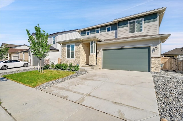 4644 Hatcher Dr, Brighton, CO 80601 - view of front of property with stone siding, concrete driveway, and a garage