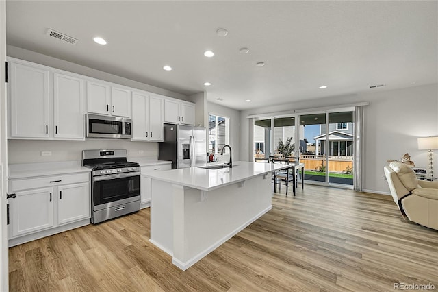 4644 Hatcher Dr, Brighton, CO 80601 - kitchen with stainless steel appliances, light wood-style flooring, recessed lighting, light countertops, and white cabinets
