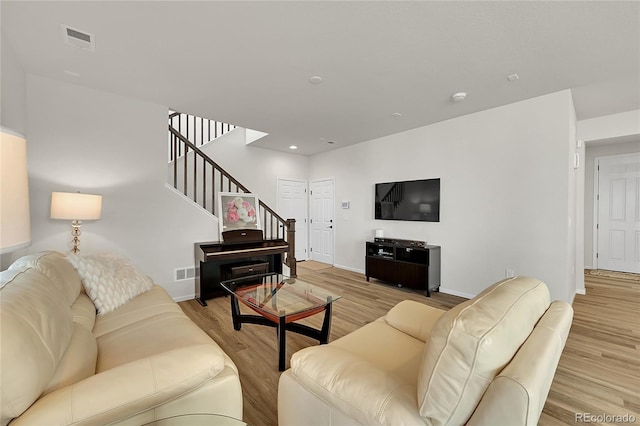 4644 Hatcher Dr, Brighton, CO 80601 - living area with stairway, light wood-style floors, and recessed lighting