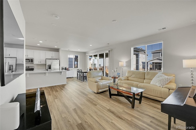 4644 Hatcher Dr, Brighton, CO 80601 - living area with light wood-style flooring, healthy amount of natural light, and recessed lighting
