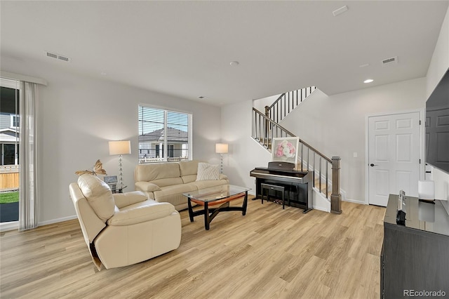 4644 Hatcher Dr, Brighton, CO 80601 - living area featuring stairs, light wood-style floors, and recessed lighting