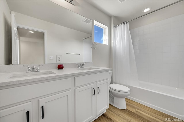 4644 Hatcher Dr, Brighton, CO 80601 - bathroom featuring double vanity, shower / bath combo, wood finished floors, and recessed lighting