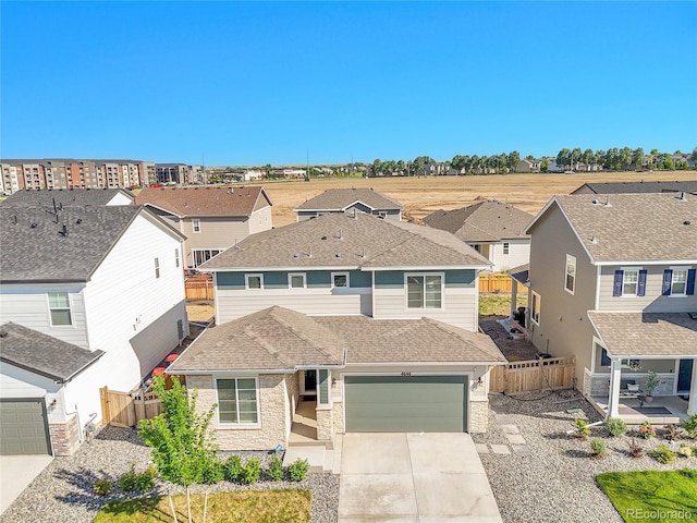 4644 Hatcher Dr, Brighton, CO 80601 - view of front of house with concrete driveway, stone siding, a residential view, an attached garage, and roof with shingles