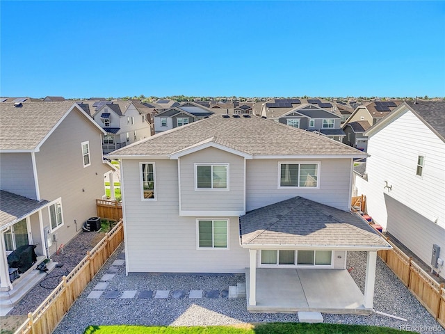 4644 Hatcher Dr, Brighton, CO 80601 - back of property featuring a shingled roof, a patio, a residential view, and a fenced backyard