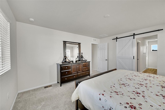 4644 Hatcher Dr, Brighton, CO 80601 - bedroom with a barn door and light colored carpet