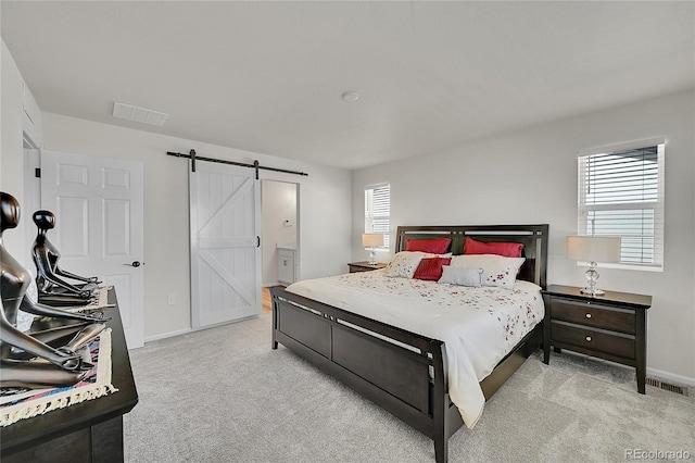 4644 Hatcher Dr, Brighton, CO 80601 - bedroom with a barn door, carpet floors, and connected bathroom