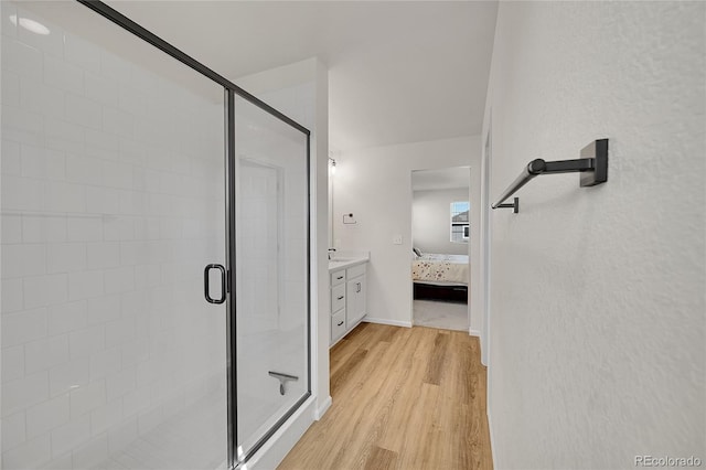 4644 Hatcher Dr, Brighton, CO 80601 - bathroom featuring ensuite bath, wood finished floors, a stall shower, and vanity
