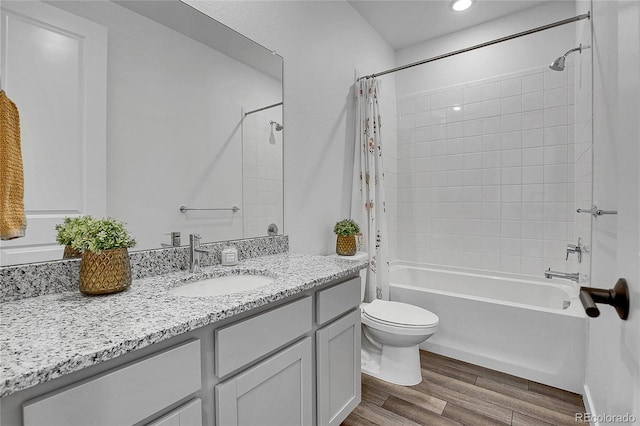 8728 Hotchkiss St, Littleton, CO 80125 - bathroom with wood finished floors, toilet, vanity, and shower / bath combo with shower curtain