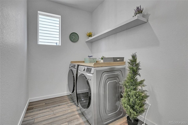 8728 Hotchkiss St, Littleton, CO 80125 - laundry area with washer and dryer, light wood-style floors, and baseboards