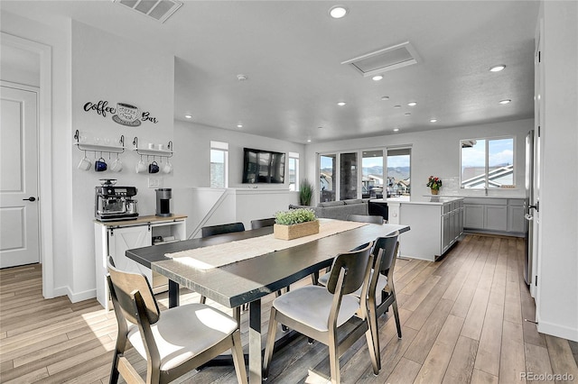 8728 Hotchkiss St, Littleton, CO 80125 - dining area with recessed lighting, plenty of natural light, light wood finished floors, and baseboards
