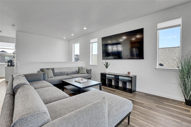 8728 Hotchkiss St, Littleton, CO 80125 - living area featuring wood finished floors, baseboards, and recessed lighting