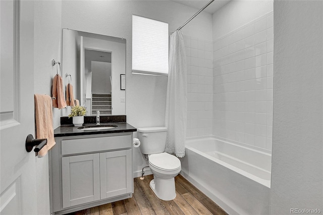 8728 Hotchkiss St, Littleton, CO 80125 - bathroom featuring wood finished floors, toilet, vanity, and shower / tub combo