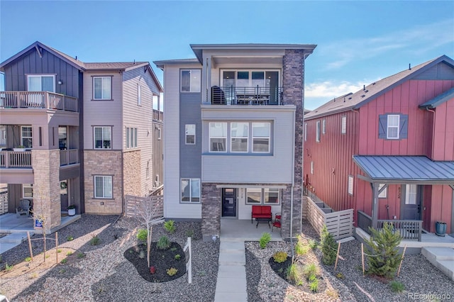 8728 Hotchkiss St, Littleton, CO 80125 - view of front of house featuring a balcony and a patio