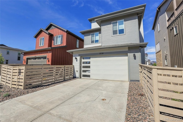 8728 Hotchkiss St, Littleton, CO 80125 - view of front facade with fence, an attached garage, and concrete driveway