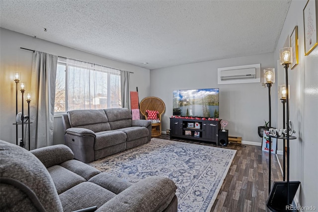 living room featuring dark wood-type flooring, a textured ceiling, and an AC wall unit