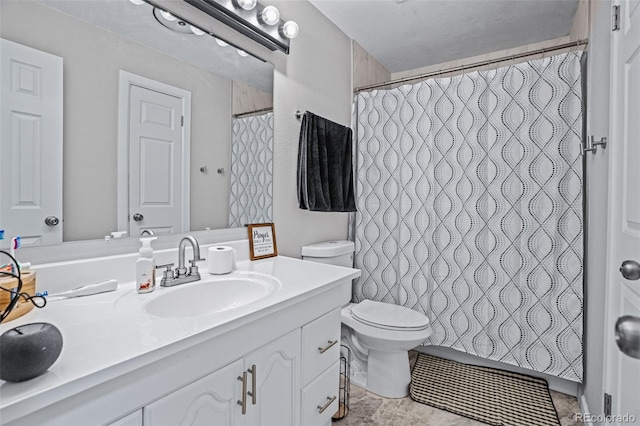 bathroom with vanity, a shower with shower curtain, and toilet